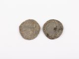 two silver coins, one of which is a woman and the other of which is a man