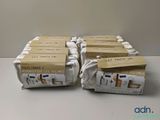 four boxes of toothpaste sitting on top of a white table