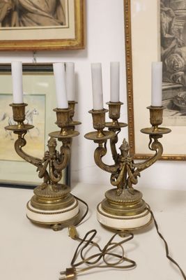 three candles that are on a table next to a mirror