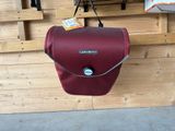 a red bag hanging on a wall in a store