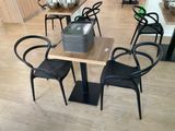 a table and chairs in a room with wood flooring