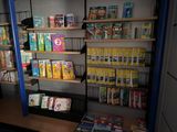 a shelf full of books and magazines in a room