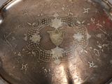 a silver plate with a picture of a woman on it