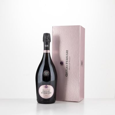 the bottle of champagne is next to the box on the table