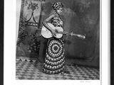 an old black and white photo of a woman with a guitar