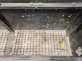 a metal grate with holes in the middle of it