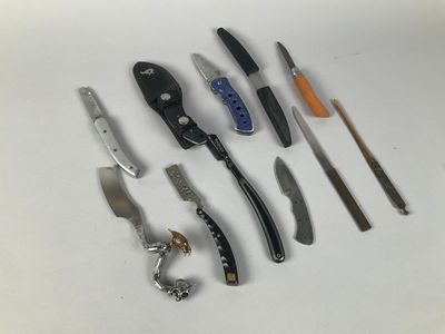 many different types of knives on a white surface