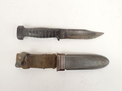 pair of old knives on a white surface with a small knife in the middle