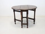 an image of a wooden table with a round top and turned legs