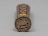 a close up of a pen with a stamp on it
