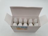 six bottles of milk in a white box on a table