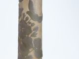 a tall candle with a bird on top of it