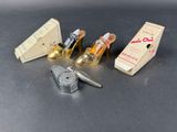 four miniature shoes and a lighter on a table