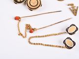 many different types of jewelry on a white surface