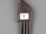 a wooden comb with a tag on it on a gray surface