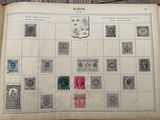 an old book with stamps on it sitting on a table