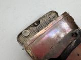 a silver lighter that is sitting on a table