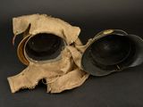 two helmets that are sitting next to each other on a black surface