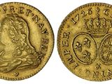 une pièce souveraine en or surmontée d'une couronne