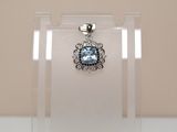 a pendant with a blue topaz stone in it