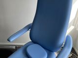 the blue chair is sitting in the corner of the room