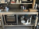 a kitchen with a stove, microwave, and other appliances