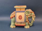 a figurine of an elephant with a box on its back