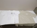 two t - shirts sitting on a table next to each other