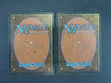 two decks of magic the gathering are shown on a black surface
