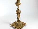 an image of a brass candle holder on a white background