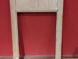 a picture of a fireplace with a red wall in the background