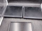 une boîte en métal contenant deux plateaux noirs
