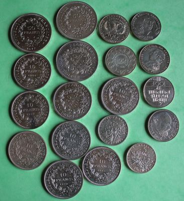 a close up of a bunch of coins on a green surface