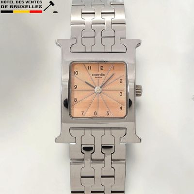 a close up of a watch on a white surface