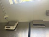 two electronic scales on a table in a room