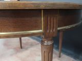 a close up of a wooden table with a clock on it