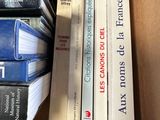 a lot of books that are stacked on top of each other