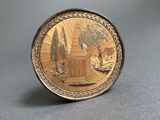 an image of a gold plate with a picture of a man and a woman