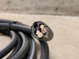 a close up view of a black cable with two copper wires