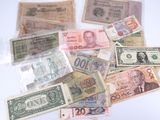 a lot of different bank notes on the table
