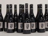 six bottles of wine are lined up in a row on a table