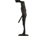 bronze statue of a man holding a baseball bat on a base