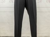 the mannequin is wearing a white shirt and black pants