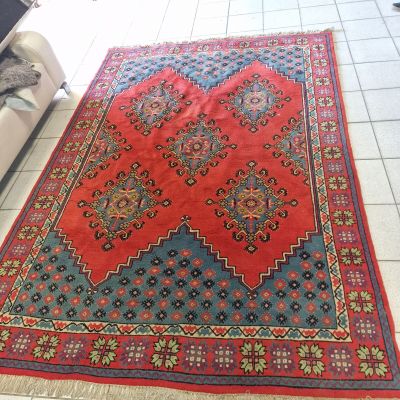 a red rug on the floor in a living room