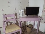 a desk with a chair and a computer on it