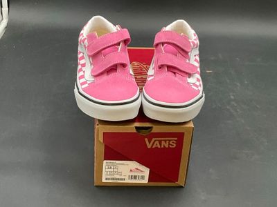 pink and white vans slip ons in a box on a table