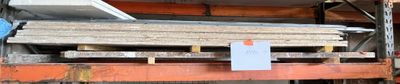 a lot of different types of steel bars in a warehouse