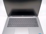 an open laptop computer sitting on top of a white table