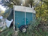 a trailer that is sitting in the middle of a field
