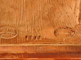 a close up of a wooden clock on a table
